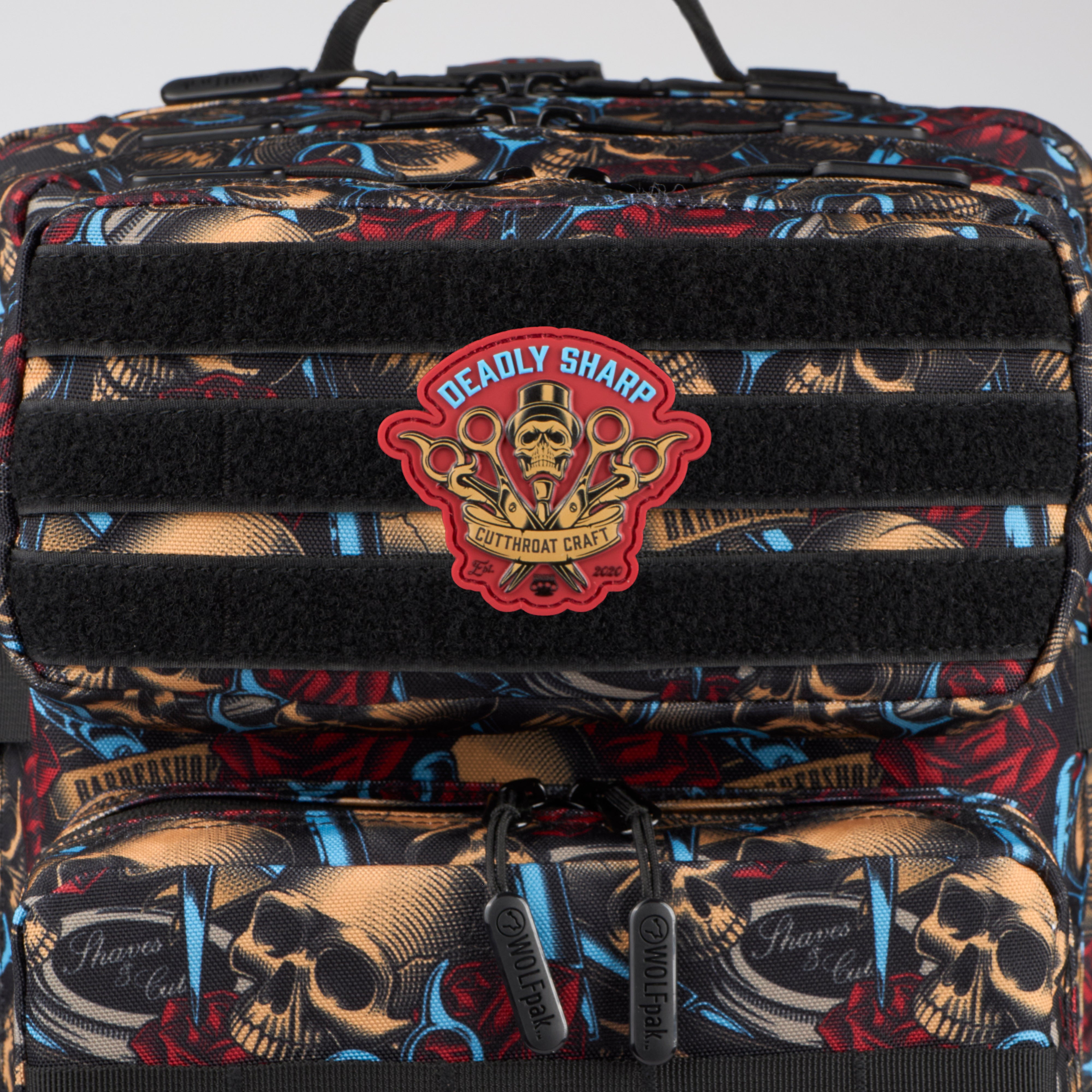 Backpack with skull design and 'Deadly Sharp' logo on a gray background