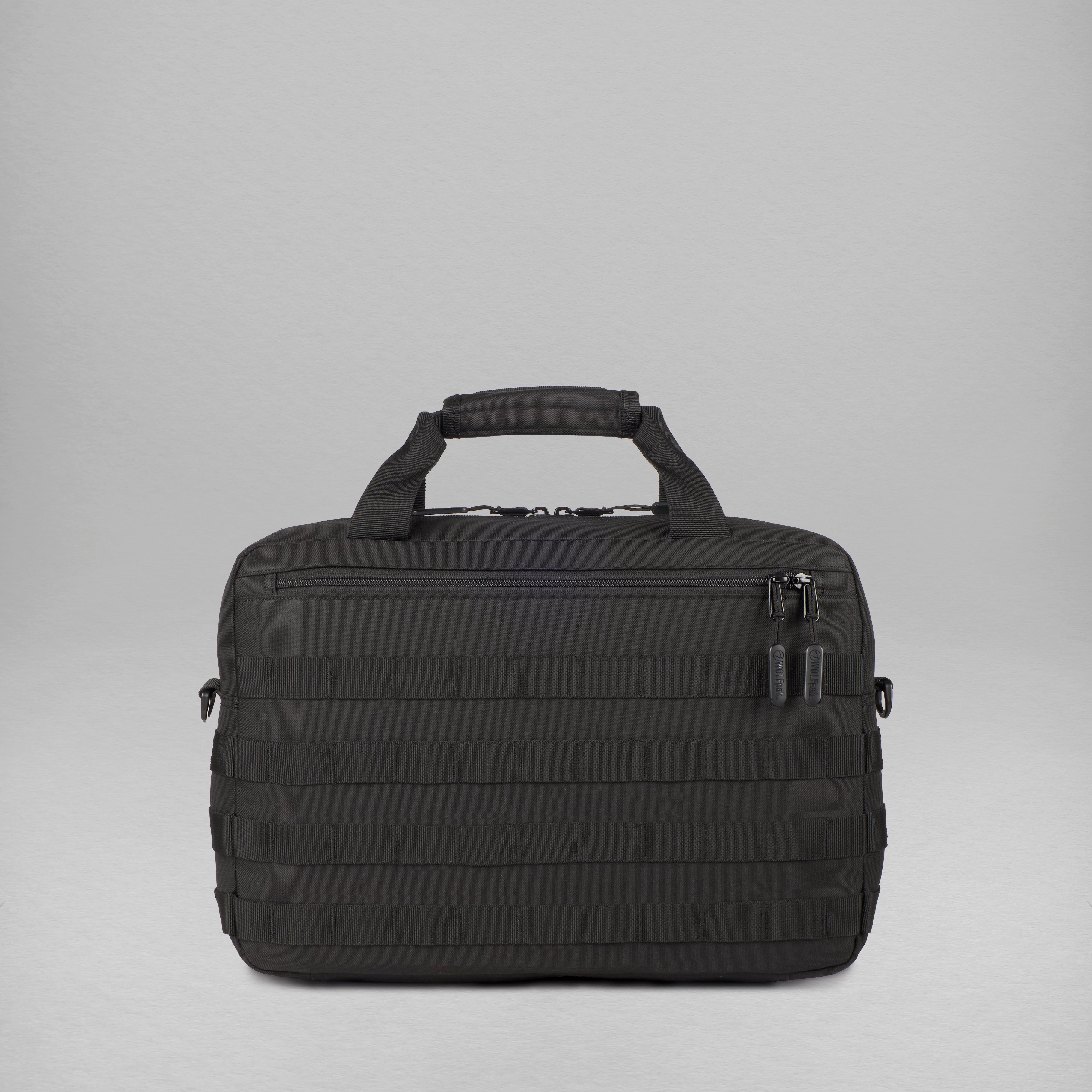 A black tactical briefcase with a top carry handle, a zippered main compartment, and a front zippered pocket, shown against a neutral gray studio background.