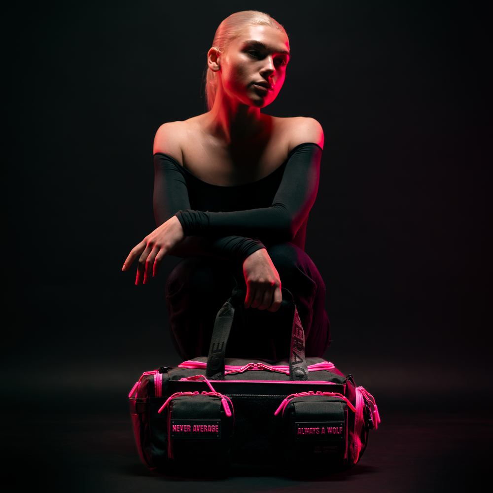 Light pink and black duffle bag.