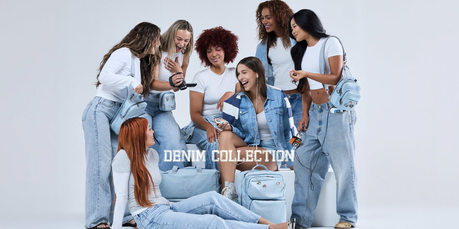 A group of seven young women posing together in matching light-wash denim jeans and denim jackets, with several light blue denim backpacks. The text 'DENIM COLLECTION' is overlaid in the center of the image against a clean white studio background.