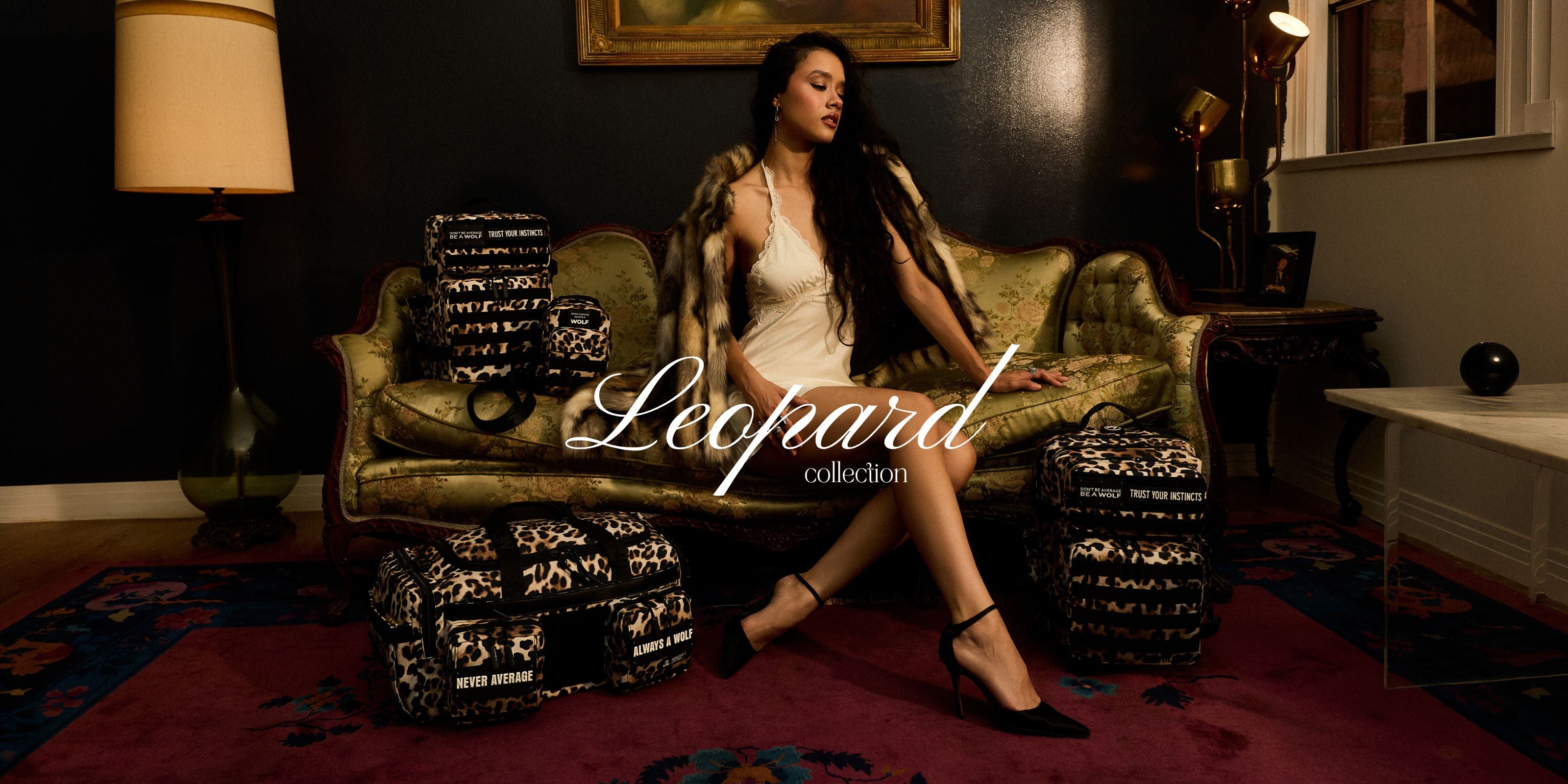 A woman sits on an ornate green velvet sofa in a dimly lit room, wearing a white slip dress and black heels, with leopard-print patterned pillows and a matching leopard-print faux fur coat draped around her. The words 'Leopard collection' are overlaid across the center.